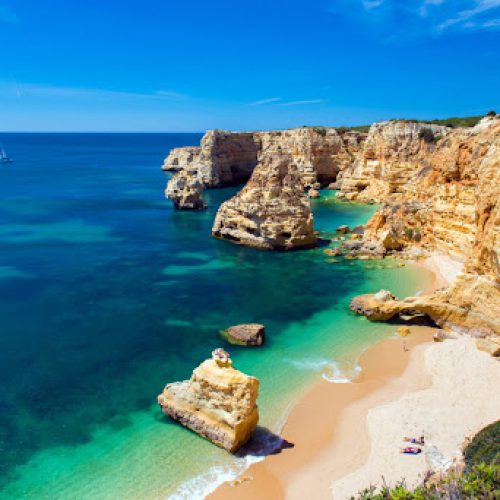 Panoramic view of the Algarve coastline with golden cliffs and turquoise ocean